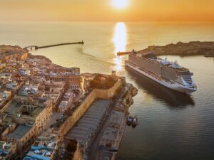 Sunsetting behind a cruise ship in port