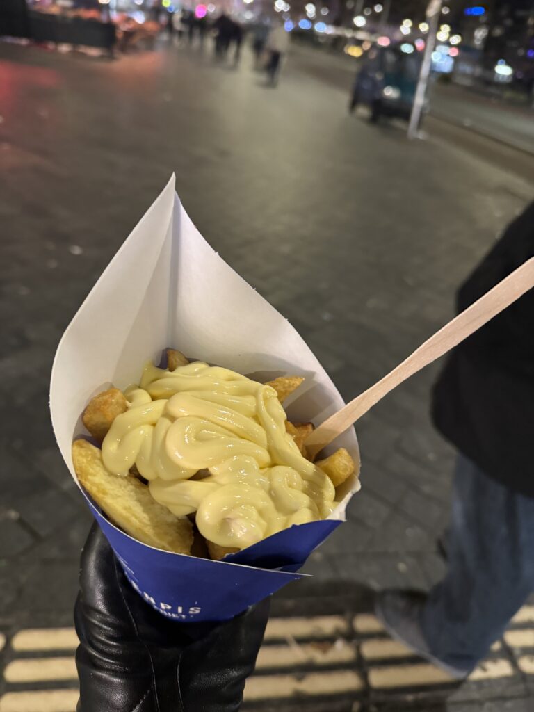 A cone of fries with truffle mayo sauce