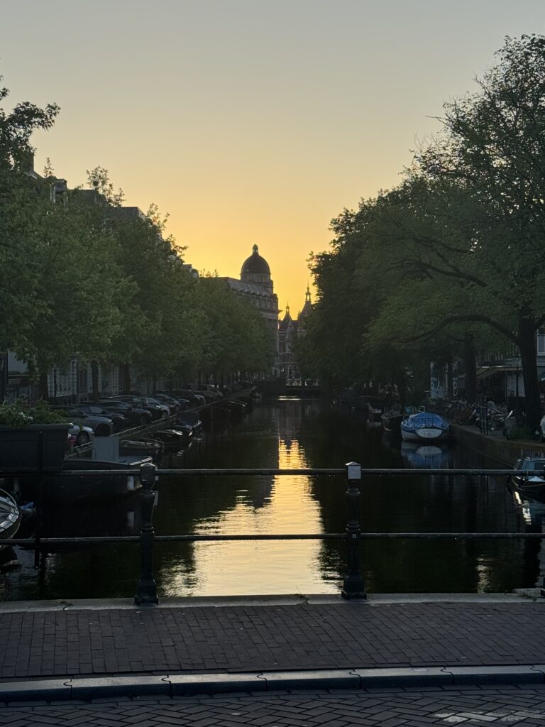 An Amsterdam canal at sunset with Wester church in the background