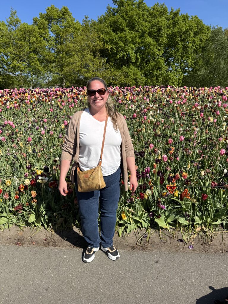 Laura at Keukenhof, in-front of multicolored tulips